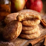 Apple cider cheesecake cookies on rustic wooden table